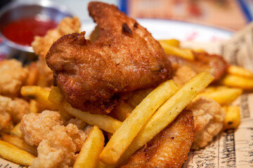 Fried food platter in Hong Kong tea restaurant, fried chicken wings and chicken nuggets