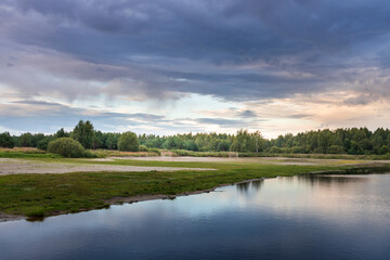 A cloudy sky with a lake in the background