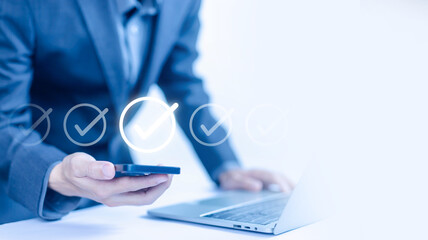 a checkmark in the survey item on a smartphone and laptop. checklist concept, task audit in a list of documents, process order, detail business verify task. tick mark evaluation in check form