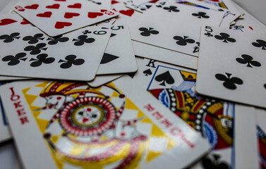 selective focus stack of playing cards or gambling or poker cards scattered or strewn, suitable for wallpaper