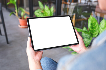 Mockup image of a woman holding digital tablet with blank white desktop screen