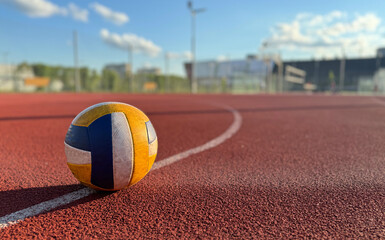 volleyball. blue with yellow color ball on the playground. volleyball cover, red. ball game