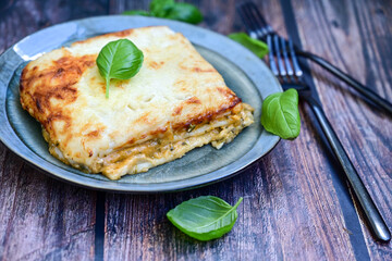  Italian Lasagna bolognese  covered with parmesan cheese  on awooden  background.