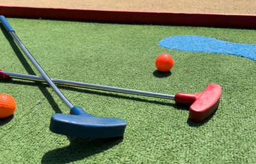 Closeup of player play mini golf with ball