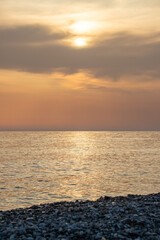 Sunset on the sea coast. Seascape orange sunset.