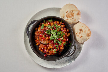 A colorful and flavorful dish of roasted eggplant and chickpeas, served in a rustic bowl