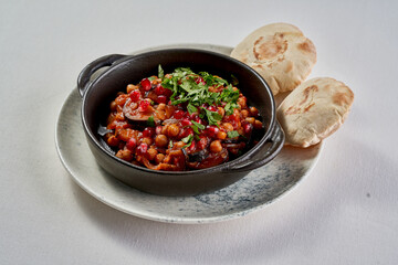 A colorful and flavorful dish of roasted eggplant and chickpeas, served in a rustic bowl