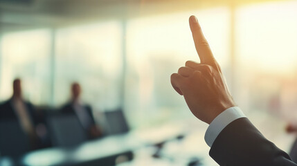 A close-up of a businessman's hand gesture as he confidently points upward during a meeting or presentation, capturing the moment of emphasis and direction, photo