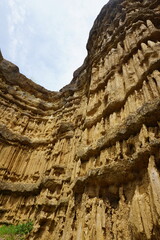 Natural rock formation with a unique and intricate pattern of vertical ridges and grooves, rough texture. Pha Chor, Grand Canyon of Chiang Mai, Thailand. Natural phenomenon