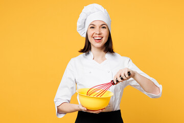 Young shocked fun chef cook baker woman wear white shirt black apron uniform toque chefs hat hold in hand bowl whisk for beating yolks isolated on plain yellow background studio. Cooking food concept.