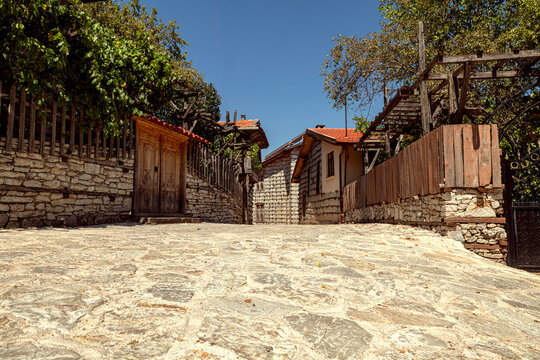 The "buttoned houses" found in the highest districts of Antalya above sea level represent the traditional residential architecture of a rural environment.