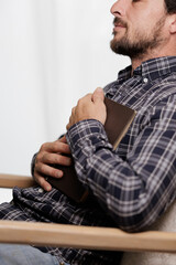 Young boy reading an interesting book. The young man entertains himself by reading a book. He...