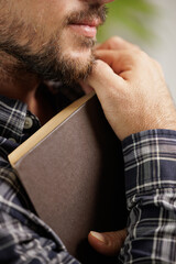 Young boy reading an interesting book. The young man entertains himself by reading a book. He smiles because he likes the story of the book and imagines the protagonists. Dream, imagine.