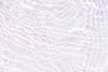 White water with ripples on the surface. Defocus blurred transparent white colored clear calm water surface texture with splashes and bubbles. Water waves with shining pattern texture background.