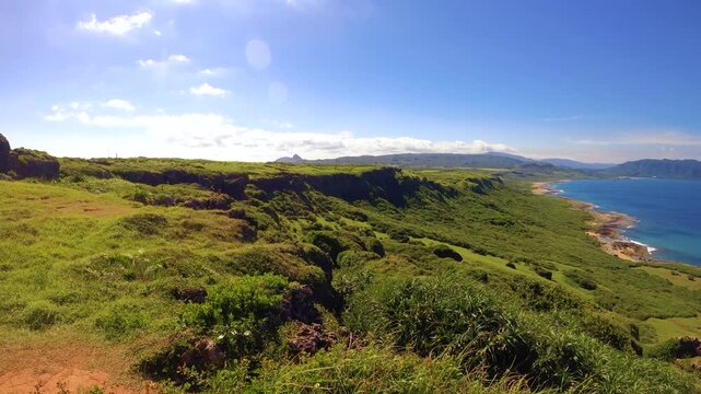 still view to beaches nature green valley with green bushes and grass look out to mountain and deep blue ocean horizon at good clear weather blue sky sunshine day time in Longpan Park