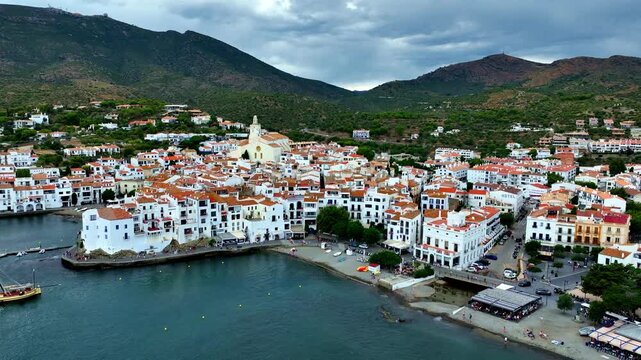Aerial view of mediterranean Spanish coastal village of Cadaques. Small holiday town on the Costa Brava. Drone view of the beach and the bay in Spain at sunset