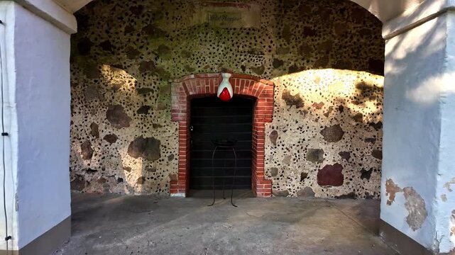 Entrance door Medieval looking landmark building in Tuja, Latvia red bricks