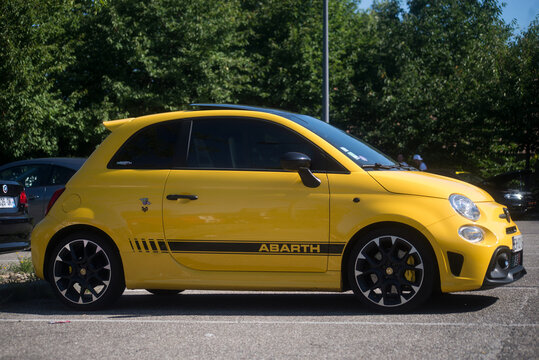 Mulhouse - France - 11 august 2024 - profile  view of yellow Fiat 500 abarth 595 parked in the street