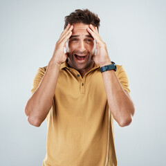 Man, scared and scream in studio portrait, anxiety and suspense for announcement on white background. Male person, stress and phobia for risk or panic for nightmare, information and shout for terror