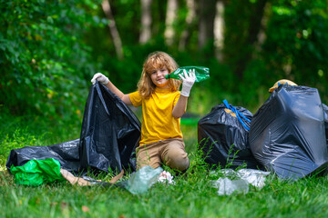Child picking plastic trash for cleaning the nature. kid Clean up garbage outdoor. Ecology concept....