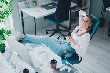 Photo of young corporate woman sit chair drink coffee modern office business center indoors