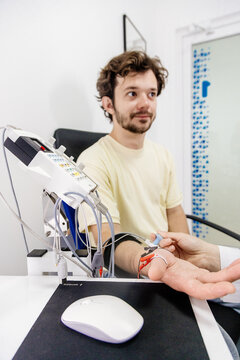 The patient undergoes an electromyography (EMG) test to assess nerve activity. Detects nerve and muscle dysfunctions. Perfect for showcasing advanced medical technologies