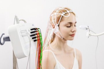 The patient is preparing for a brain activity scan. Ideal for illustrating modern medical...