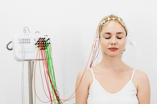 The patient is preparing for a brain activity scan. Ideal for illustrating modern medical diagnostics and healthcare technology.