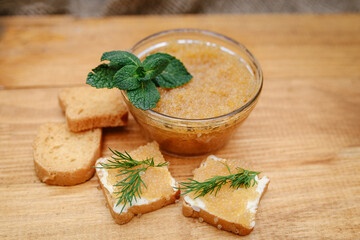 Pike caviar in a jar and with tartlets on a wooden background close-up with copy space