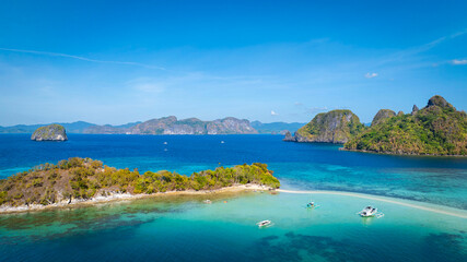 Aerail view of  tropical exotic island sand bar separating sea in two with turquoise  in El Nido, Palawan, Philippines.