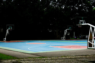 A basketball court with three hoops and a net