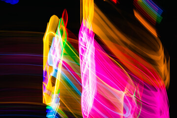 A colorful, abstract painting of a person with a pink and yellow swirl. The painting is full of bright colors and seems to be a representation of movement and energy