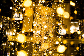A large chandelier with many lights hanging from it, creating a warm and inviting atmosphere. The lights are scattered throughout the room, illuminating the space