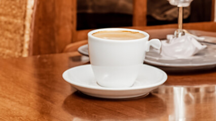 Fototapeta premium A cup of coffee on a table panorama view.