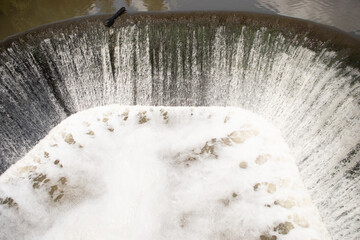 Dam on the river. Drainage of water. The flow of water.