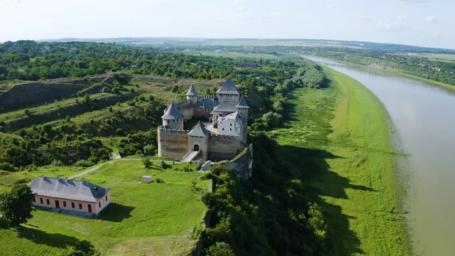 Khotyn Fortress (Ukrainian: Хотинська фортеця; Romanian: Cetatea Hotinului)  fortress of the 10th-18th centuries, huge walls towers on the banks  Dniester,  drone flies by at dawn aerial photography