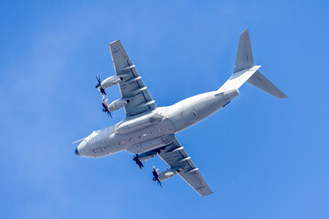 Heavy lift military cargo aircraft overhead.