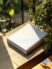 Fototapeta premium white soft cover book lying on the table, birds eye view