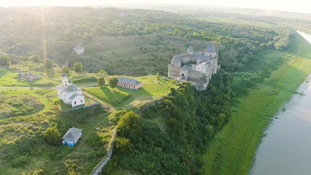 Khotyn Fortress (Ukrainian: Хотинська фортеця; Romanian: Cetatea Hotinului)  fortress of the 10th-18th centuries, huge walls towers on the banks  Dniester,  drone flies by at dawn aerial photography