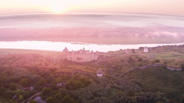 Khotyn Fortress (Ukrainian: Хотинська фортеця; Romanian: Cetatea Hotinului)  fortress of the 10th-18th centuries, huge walls towers on the banks  Dniester,  drone flies by at dawn aerial photography