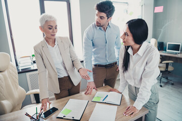 Fototapeta premium Photo of two employees mature boss woman conference collaborating new project office working together in modern workspace