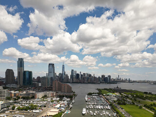 Naklejka premium Marine in New York City Skyline with Urban Skyscrapers and yachts. New York City skyline, cityscape of Manhattan in USA. Panoramic view on Manhattan. New York Harbor.