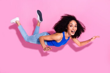 Photo of excited girl flying levitate isolated pastel color background