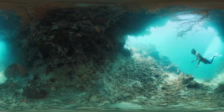 VR 360 underwater footage of the male freediver swimming on the healthy coral reef in Raja Ampat region in Indonesia