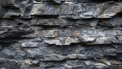 Natural stone wall showcasing layered slate rock textures in natural lighting