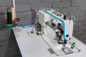 Sewing machine in the workshop for making a new leather cover for the steering wheel on a car.