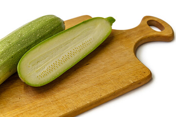 fresh raw zuccinies on a cutting board close up