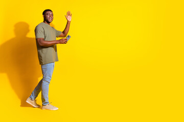 Fototapeta premium Photo of cheerful nice attractive man wear trendy khaki clothes store mall empty space isolated on yellow color background
