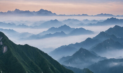 Majestic Mountain Range Illuminated by Soft Sunrise Glow Over Misty Valley