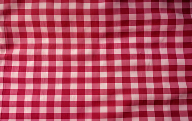 Close-Up of Red and White Checkered Fabric. Soft, stretchy material creates a textured backdrop, perfect for a variety of design projects. The classic checkered pattern